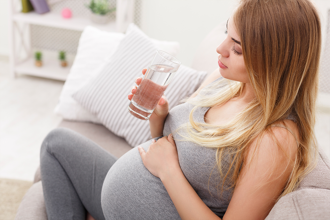 Pregnant woman drinks water