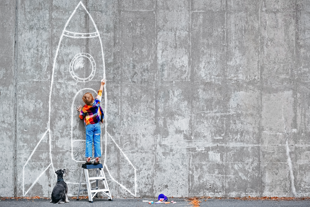 Boy draws a picture on the wall