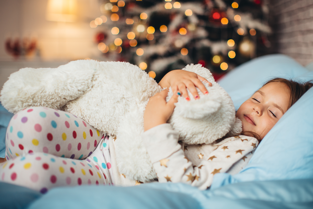 Boy sleeping with his teddy bear